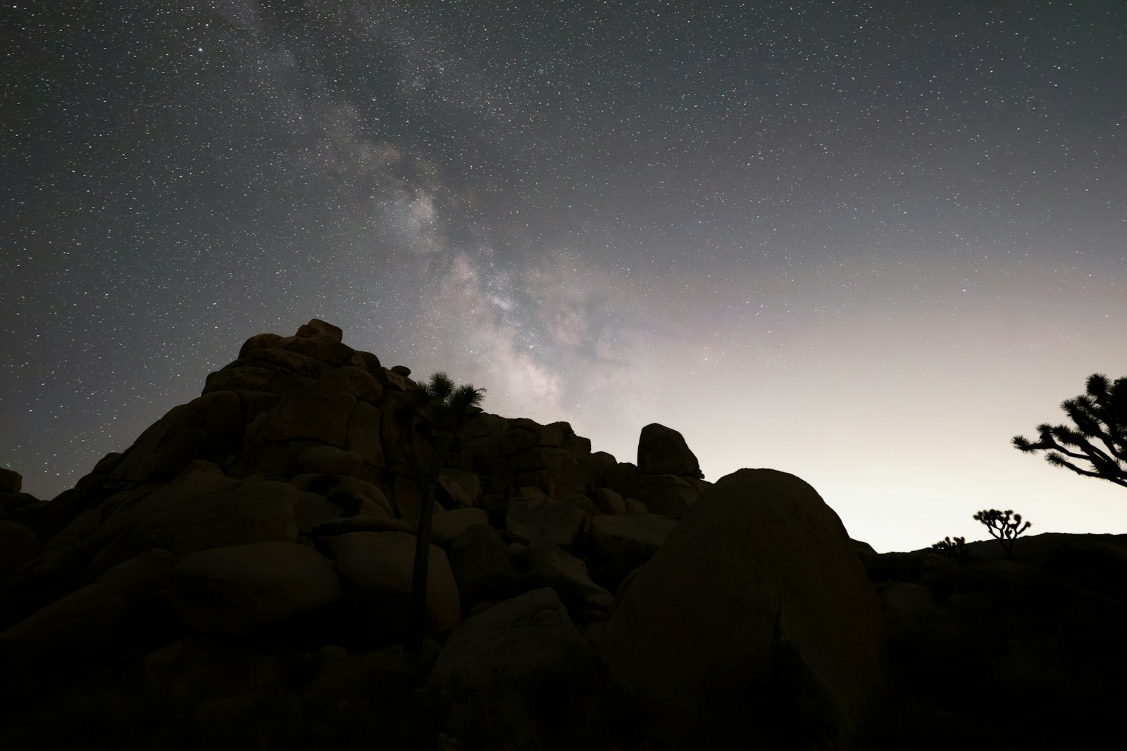 Milky way over rocky desert landscape at night